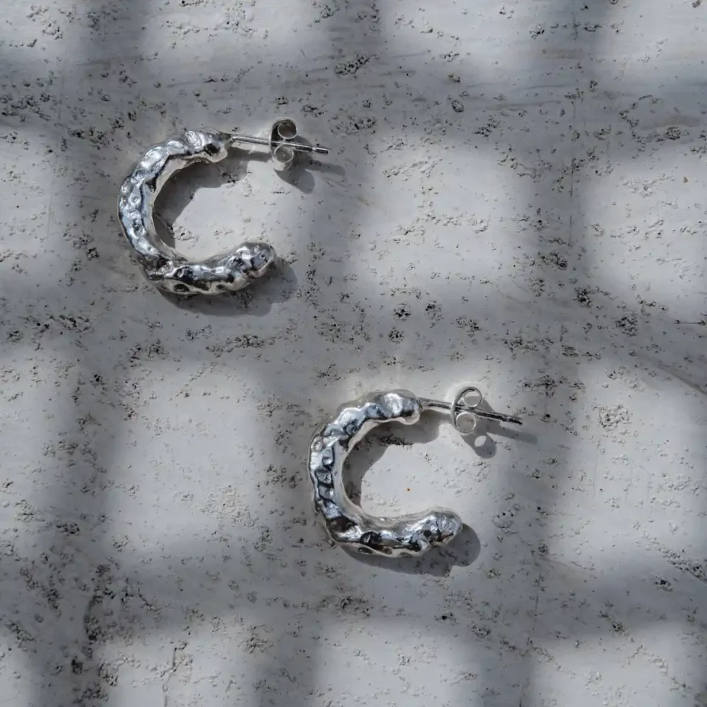 Pair of handmade textured sterling silver hoop earrings with organic finish